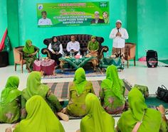 some people are sitting on the floor with green cloths