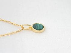 This delicate and minimalist necklace is adorned with a flat, 6mm disc-shaped natural malachite, mounted on a gold-plated chain. Malachite, recognizable by its intense green color and unique patterns, is a stone appreciated since ancient Egypt for its protective qualities and spiritual virtues. It symbolizes transformation, helping to overcome emotional blockages and encourage change. With a hardness of 3.5 to 4 on the Mohs scale, malachite is a relatively soft stone that requires delicate care. Malachite Necklace, Gold Chain Choker, Mohs Scale, Princess Necklace, Jewelry For Her, Minimalist Necklace, Chain Choker, Green Stone, Ancient Egypt