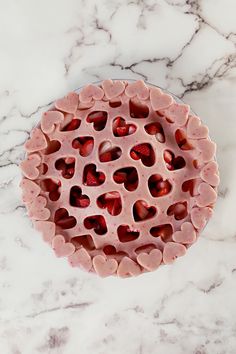 a bowl filled with hearts sitting on top of a marble counter