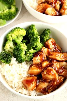 two bowls filled with rice and chicken next to broccoli