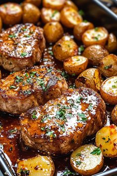 some meat and potatoes in a pan with seasoning on top for garnish