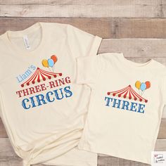 two t - shirts that say three ring circus, three balloons and the words lions on them