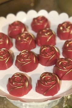 red chocolates with gold foil roses on a white plate