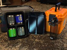 an orange and black case filled with different types of lighters on top of a counter