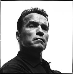 a black and white photo of a man looking off into the distance with his eyes closed