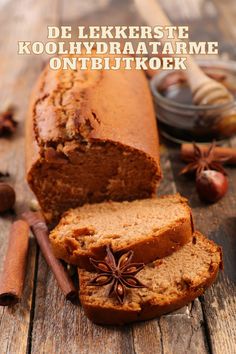 a loaf of bread sitting on top of a wooden table next to an apple and cinnamon