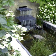 there is a water fountain in the garden