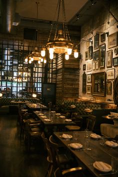 a dimly lit restaurant with wooden tables and chairs