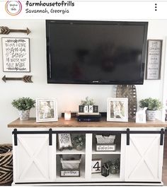 a flat screen tv mounted to the side of a wooden entertainment center in a living room