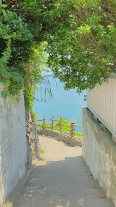 the stairs lead down to the water from the cliff side area in front of the house