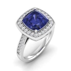 Introducing our exquisite cushion cut tanzanite and diamond ring, a true symbol of elegance and sophistication. Crafted with meticulous attention to detail, this stunning piece showcases a vibrant cushion cut tanzanite at its center, radiating a captivating blue hue. Surrounding the tanzanite are dazzling diamonds, meticulously set to enhance its brilliance and create a mesmerizing sparkle. With its timeless design and impeccable craftsmanship, this ring is the perfect accessory for any special Elegant Sapphire Ring With Square Cut And Accent Stones, Cushion Cut Sapphire Diamond Ring For Formal Occasions, Elegant Square Cut Sapphire Ring With Accent Stones, Formal Sapphire Cushion Cut Diamond Ring, Formal Tanzanite Cushion Cut Ring, Luxury Cushion Cut Sapphire Ring With Halo Setting, Luxury Tanzanite Cushion Cut Ring, Elegant Square Cut Sapphire Ring With Diamonds, Elegant Cushion Cut Gemstone Halo Ring