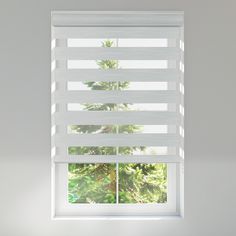 a window with white blinds in front of it and trees out the window behind it