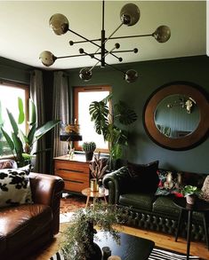 a living room filled with furniture and lots of plants