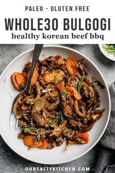 a white plate topped with beef and carrots next to a bowl of sauce on the side