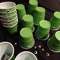 many green cups are stacked on top of each other