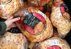 a pile of bread wrapped in plastic and packaged for sale at a grocery store or restaurant