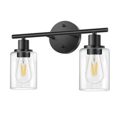 two light bathroom fixture with clear glass shades and black metal finish, on an isolated white background