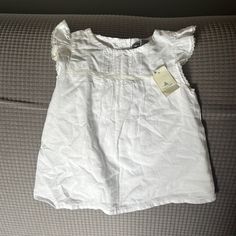 Girls White Gap Shirt Size 18-24 Months Nwt Gap Cotton Tops For Summer, Gap Ruffled Short Sleeve Tops, Gap Ruffled Tops For Summer, Summer Ruffled Tops By Gap, Summer Ruffled Tops From Gap, Cute Short Sleeve Gap Tops, Gap Cotton Tops For Playtime, White Cotton Blouse By Gap, Gap Cotton Short Sleeve Blouse