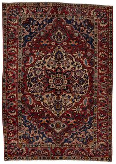 an antique persian rug with red and blue colors