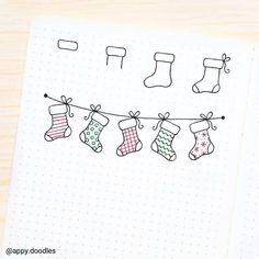 an open notebook with christmas stockings hanging on a line