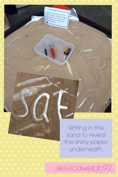 writing in the sand to reveal the shiny paper underrean with scissors and crayons