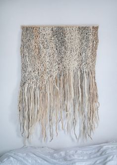 the wall hanging is made out of yarn