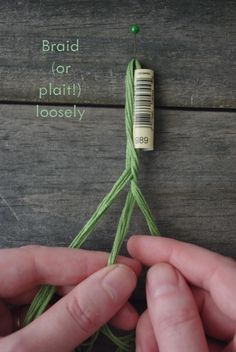 two hands are stitching together yarn on a wooden surface with the words braid for plait loose