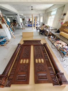 two large wooden doors sitting inside of a building