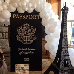 balloon arch in front of the eiffel tower and sign for passport united states of america