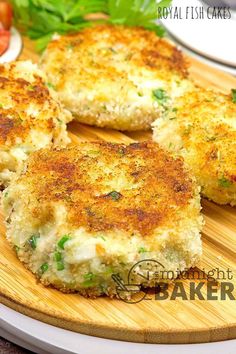 two crab cakes on a wooden cutting board