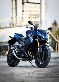 a blue motorcycle parked in front of a building