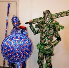 two people made out of soda cans are standing next to each other and one is holding a baseball bat