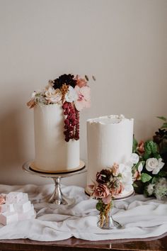 two white wedding cakes with flowers on top