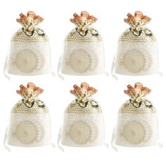 six small white bags with bows on them