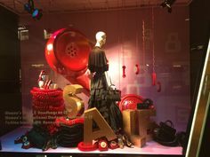 a display case with red and gold items in the shape of letters, numbers, and telephones