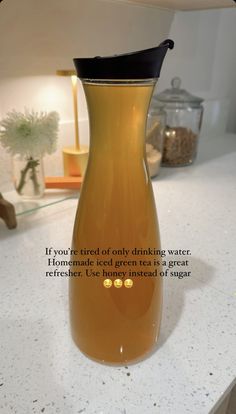 a glass pitcher filled with liquid sitting on top of a counter