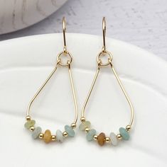 "Handmade Beaded Hoop Earrings - Stand out from the crowd with these bold Lane earrings! These gold and multi-colored Amazonite teardrop hoops are sure to make a statement. Enjoy the opulence of the natural Aventurine stone and the sleek design - they'll will go with anything! * Approximately 1.75\" long * Made with 14k Gold Filled wire * Genuine Amazonite Gemstones * Polished to a high shine * Handmade in Montana * Sent in a ribboned gift box with polishing cloth ----- OUR MATERIALS -----  *STE Gold Teardrop Jewelry With Colorful Beads, Gold Teardrop Hoop Earrings With Dangling Beads, Gold Teardrop Beaded Hoop Earrings, Gold Teardrop Beaded Earrings, Gold Hoop Earrings With Colorful Beads For Everyday, Gold Teardrop Earrings With Colorful Beads, Everyday Gold Hoop Earrings With Colorful Beads, Everyday Teardrop Earrings With Dangling Beads, Diy Gold Earrings