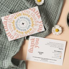 a card and some flowers on a table