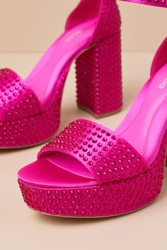 The D'Amelio Footwear Mayvinna Ultra Pink Rhinestone Platform Ankle Strap Sandals were made to stand out from the crowds! Sparkling pink rhinestone studs adorn sleek woven satin as it shapes these glam heels with an almond footbed and a wide vamp strap, all atop a 1.5"" toe platform. A structured heel cup supports a slender ankle strap with an adjustable round buckle. A sturdy, sky-high block heel completes the eye-catching look! 4" wrapped block heel. Cushioned insole. Felted rubber sole has no Pink Open Toe Sandals With Rhinestones, Pink Embellished Open Toe Sandals, Pink Crystal Embellished Heels, Pink Rhinestone Round Toe Sandals, Pink Embellished Ankle Strap Heels, Pink Crystal Embellished Sandals For Spring, Pink Crystal-embellished Sandals For Spring, Glamorous Pink Embellished Sandals, Satin Platform Heels