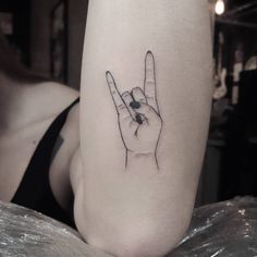 a woman's arm with a tattoo on it and a peace sign in the middle