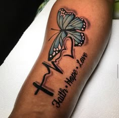 a butterfly with the words faith hope love and a cross on it's arm