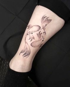 a woman's leg with a tattoo on it and a fish in the middle