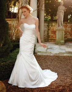 a woman in a wedding dress standing outside