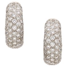 These earrings feature a beautiful and classic design with a C-shaped hoop encrusted in sparkling pave diamonds. The diamonds are of high quality, weighing a total of 3.80 carats, have a near-colorless appearance, and are very clean, with only minor inclusions visible under 10x magnification. They are signed, LW. The earrings are made of 18k white gold, a durable and luxurious metal that complements the diamonds beautifully. The omega backs provide a secure and comfortable fit. Overall, these Women's Pave Diamond C-Hoop Earrings are stunning and sophisticated, a piece of jewelry that will surely add elegance to any outfit. The earrings are in excellent pre-owned condition. Length, 21mm Width, 8mm Total Carat Weight, 3.80 carats Diamond Color and Clarity, G/VS2 Weight, 15 grams Luxury Diamond White Earrings With Pave Setting, Luxury Huggie Earrings With Pave Setting In Cubic Zirconia, Luxury Diamond Huggie Earrings With Pave Setting, Luxury Pave Setting White Gold Huggie Earrings, Luxury Diamond White Hoop Earrings With Pave Setting, Luxury Diamond Hoop Earrings With Pave Setting, Luxury Brilliant Cut Diamond Huggie Earrings, Luxury Diamond Huggie Earrings With Single Cut Diamonds, Luxury White Gold Huggie Earrings With Pave Setting