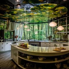 a kitchen with an island in the middle and lots of lights hanging from the ceiling