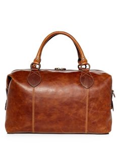 Travel in style with the clean lines and durable design of this leather bag from Frye. Classic Cognac Business Duffle Bag, Classic Cognac Travel Bag For Business Trips, Classic Brown Travel Bag With Leather Trim, Classic Cognac Satchel For Travel, Chic Brown Duffle Bag For Travel, Classic Weekender Bag With Leather Trim For Business Trips, Timeless Cognac Satchel For Travel, Chic Leather Duffle Bag, Elegant Cognac Duffle Bag For Travel