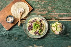 an image of food that is on the table with utensils and spoons