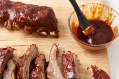 bbq ribs and barbecue sauce on a cutting board