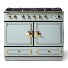 an old fashioned blue stove with gold knobs