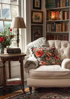 a living room filled with lots of furniture and bookshelves full of books next to a window